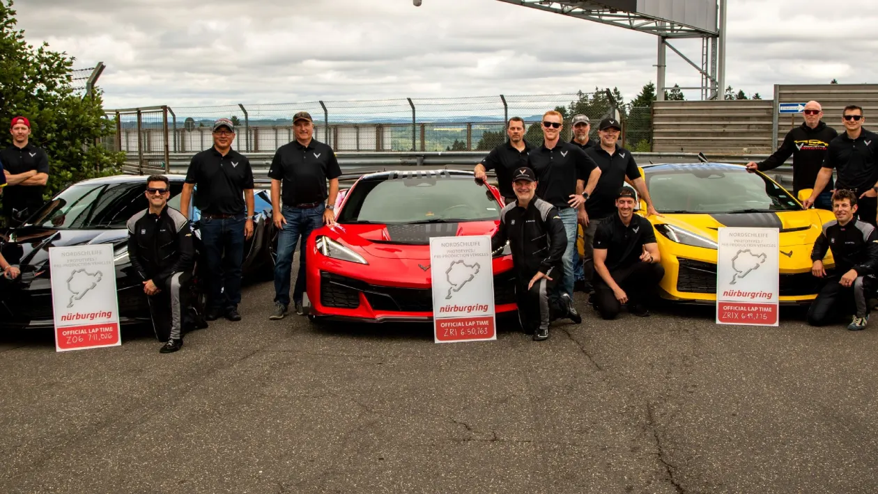 Corvette ZR1X team posing with their cars and official Nurburgring lap time boards