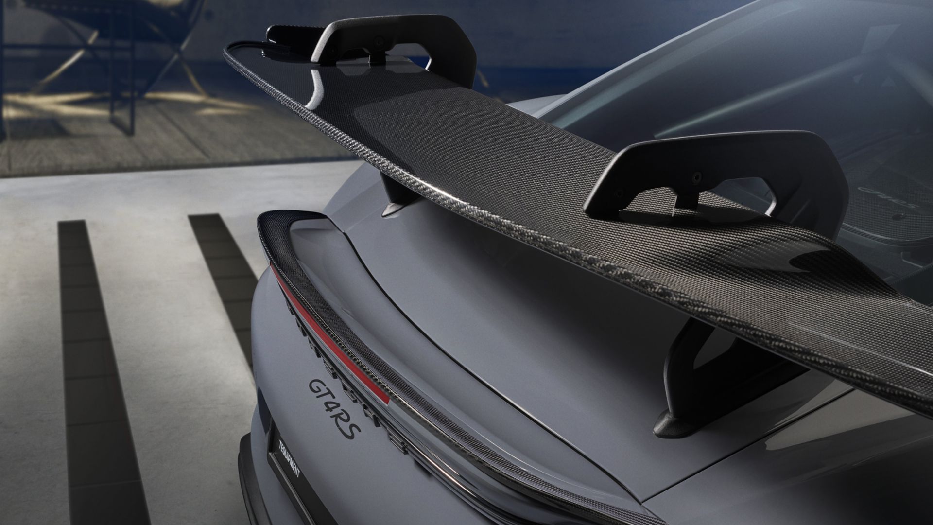 Close-up of the GT4 RS swan-neck wing mounting, showing clean underside